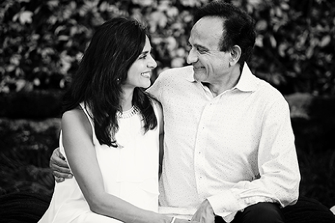 Husband and wife looking at each other holding hands and smiling. black and white photo